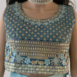 Blue cropped blouse with gold embroidery and a gradient skirt
