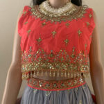 Coral pink and pale blue ensemble with golden embellishment lehenga