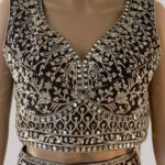 Black, gold, and silver beadwork choli with peach skirt lehenga