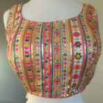 Beige color with Red and Green flower work Sleeveless Stitched Blouse