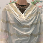 White dupatta with golder embroidery  and tassel.