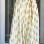 Cream Golden based skirt with matching sleeveless peal worked Blouse/Choli