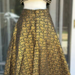 Black golden base skirt with matching pipe worked sleeveless Blouse/Choli